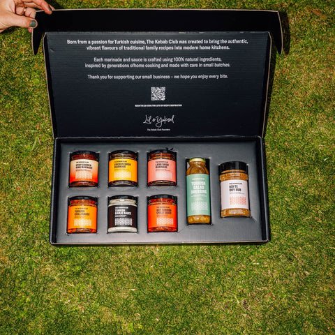 Set of spice jars in a black box on grass